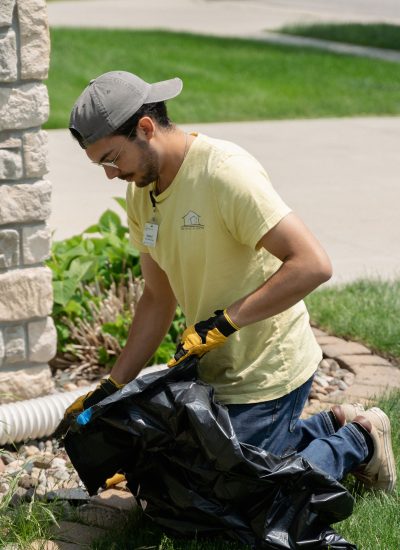 Handyman pulling weeds out of a garden