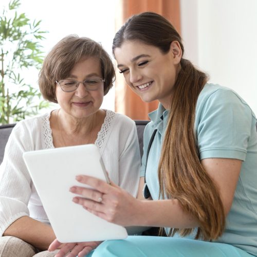 medium-shot-smiley-women-looking-tablet
